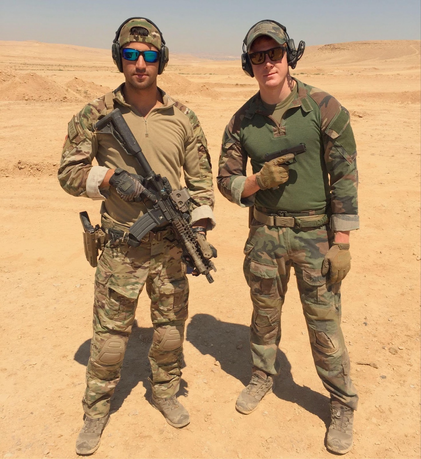 Two Soldiers geared up in the desert